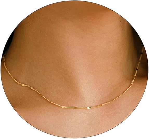 Fine gold-coloured necklace shown across the front of a neck